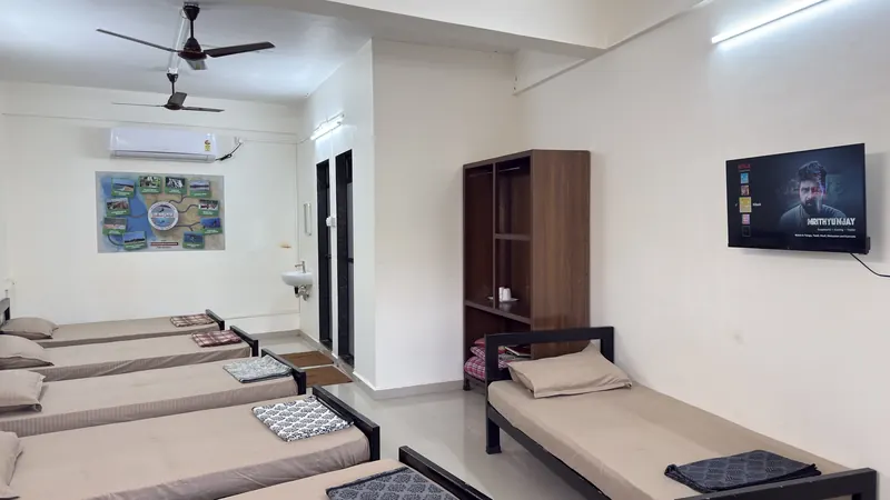 The Six Bed Room at Konkan Central Family Rooms, Kankavli: six single beds, AC and TV in one 400 sq ft room