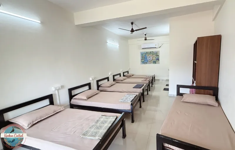 Six Bed Room, row of single beds with the wardrobe